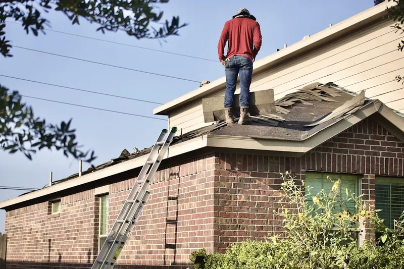 Professional roofer working on a residential roof in Reeves Crossing